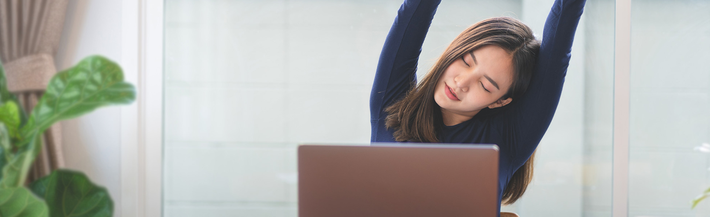 Woman stretching at her desk