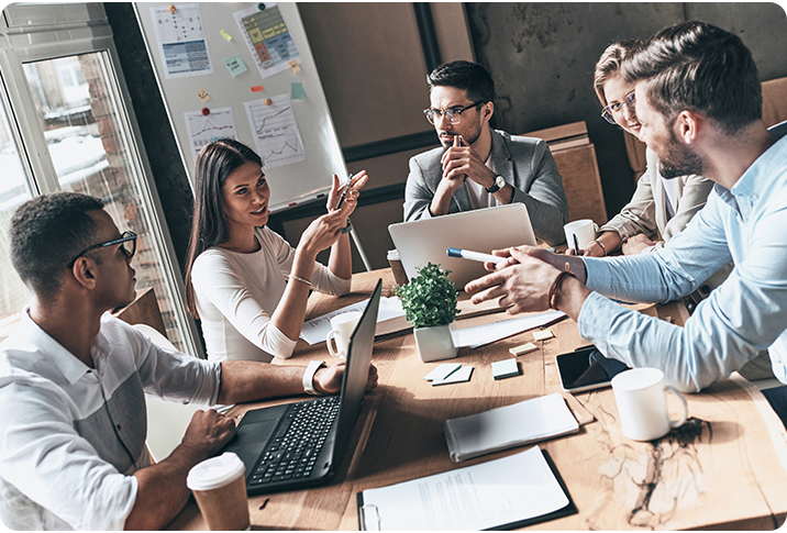employees talking around office table