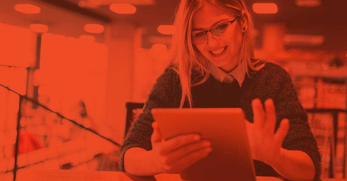 Woman smiling while using a tablet