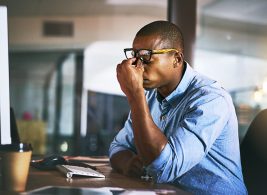 Stressed employee sitting at desk