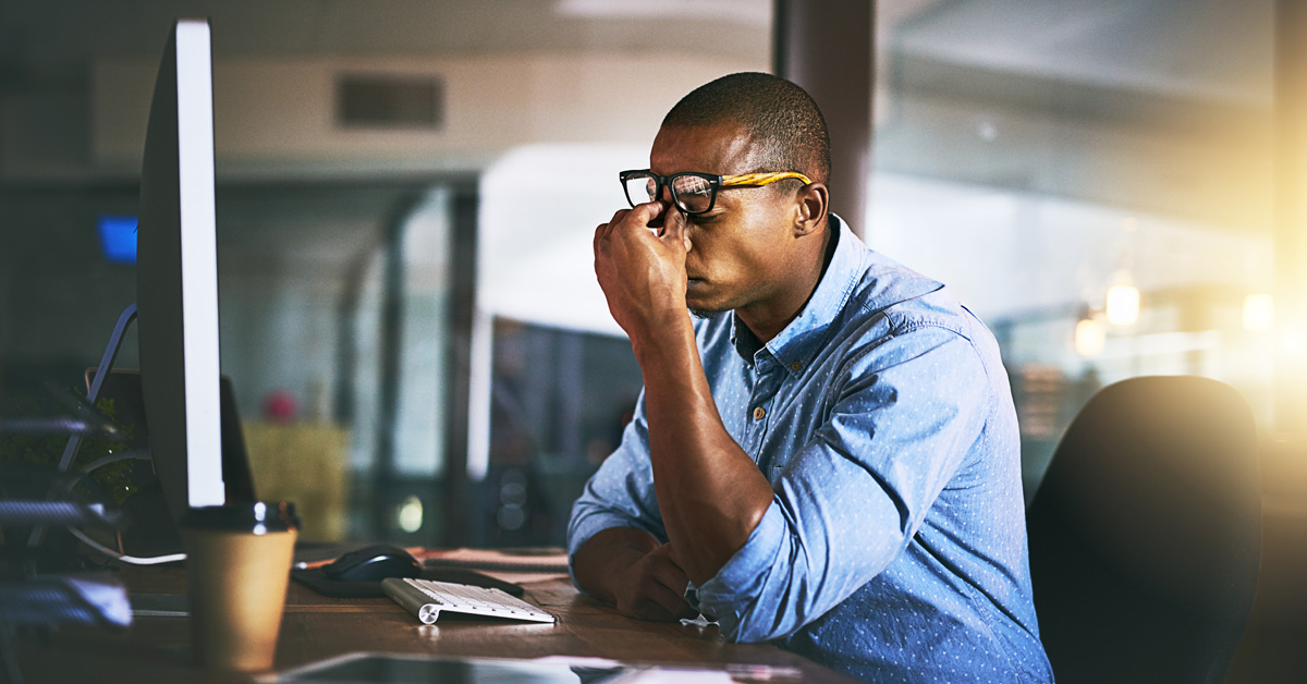Stressed employee sitting at desk