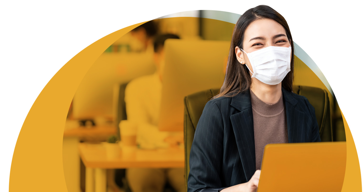 Woman working at desk with mask on