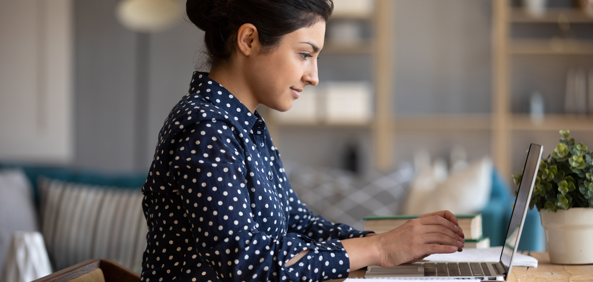 Woman working on laptop at desk