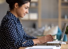 Woman working on laptop at desk