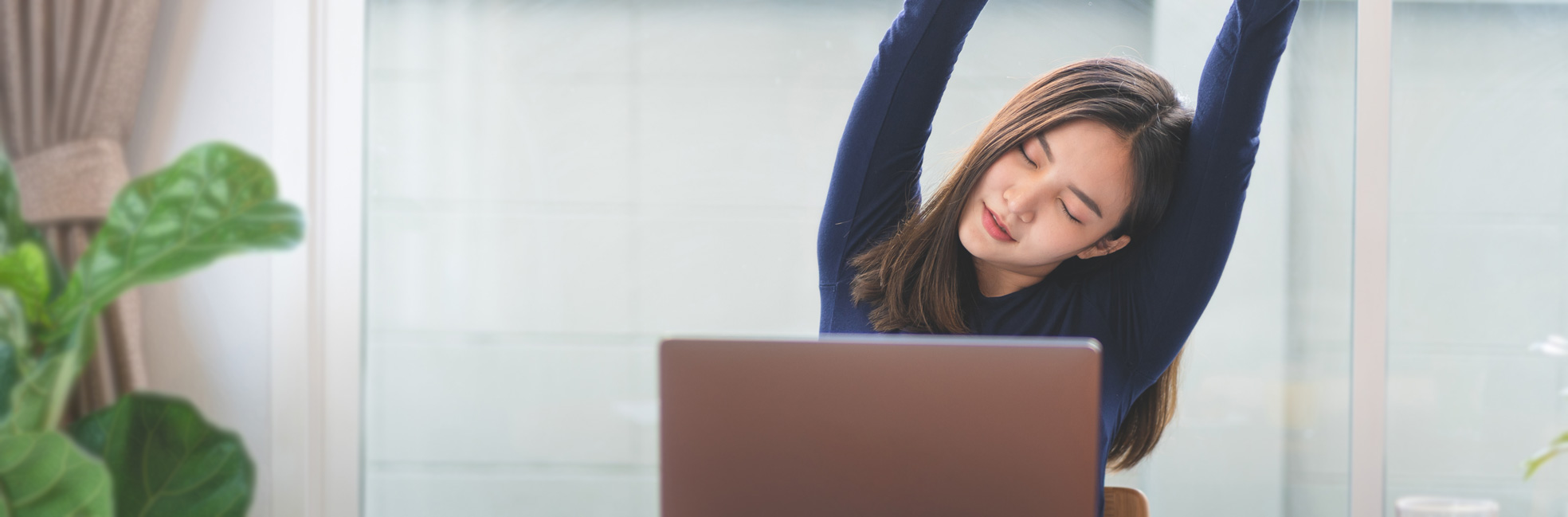 Woman stretching at her desk