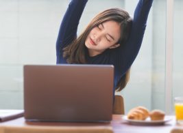 Woman stretching at her desk