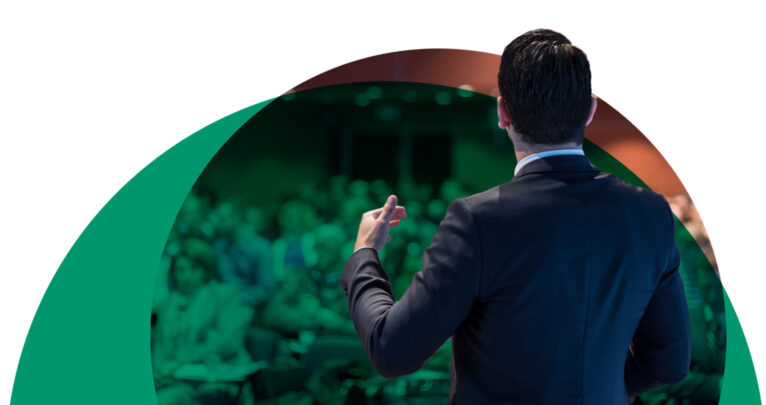 Speaker at a conference in front of a crowd