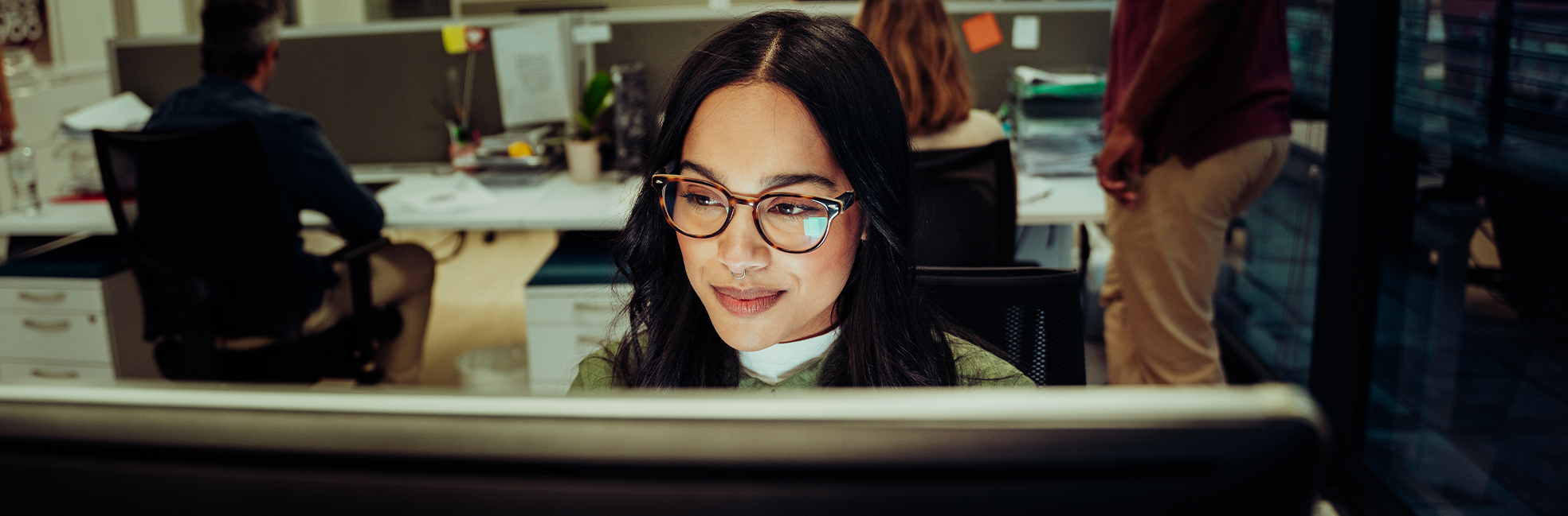 Woman with glasses working on computer