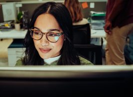 Woman with glasses working on computer