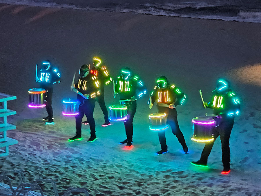Neon Drumline on the beach at Idea Exchange 2025